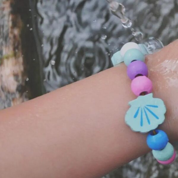 Wooden shell bead bracelet on a child's arm